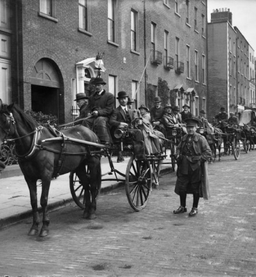 Historical street scene with horse-drawn carriages
