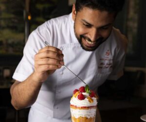 Chef garnishing a dessert