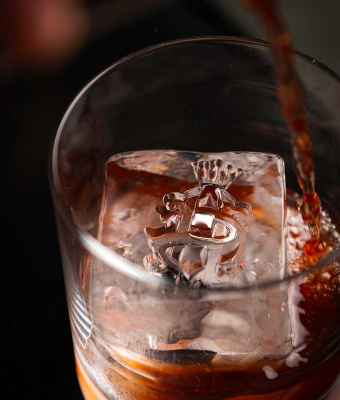 Cocktail being poured over ice