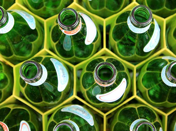 Green glass bottles in honeycomb pattern