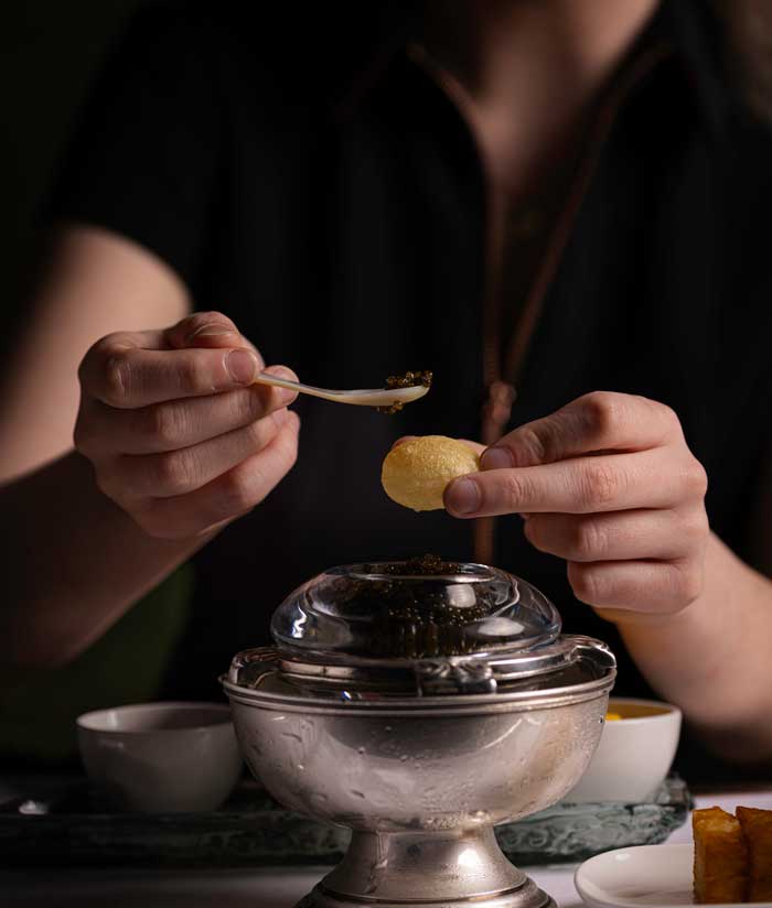 Hands preparing food in dark setting