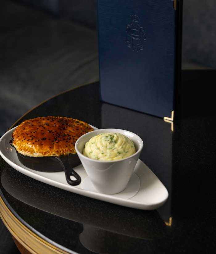 Crab cake with sauce on white plate