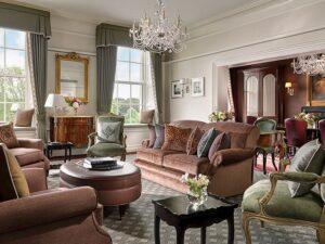 Luxurious living room with elegant furniture, chandeliers, and large windows